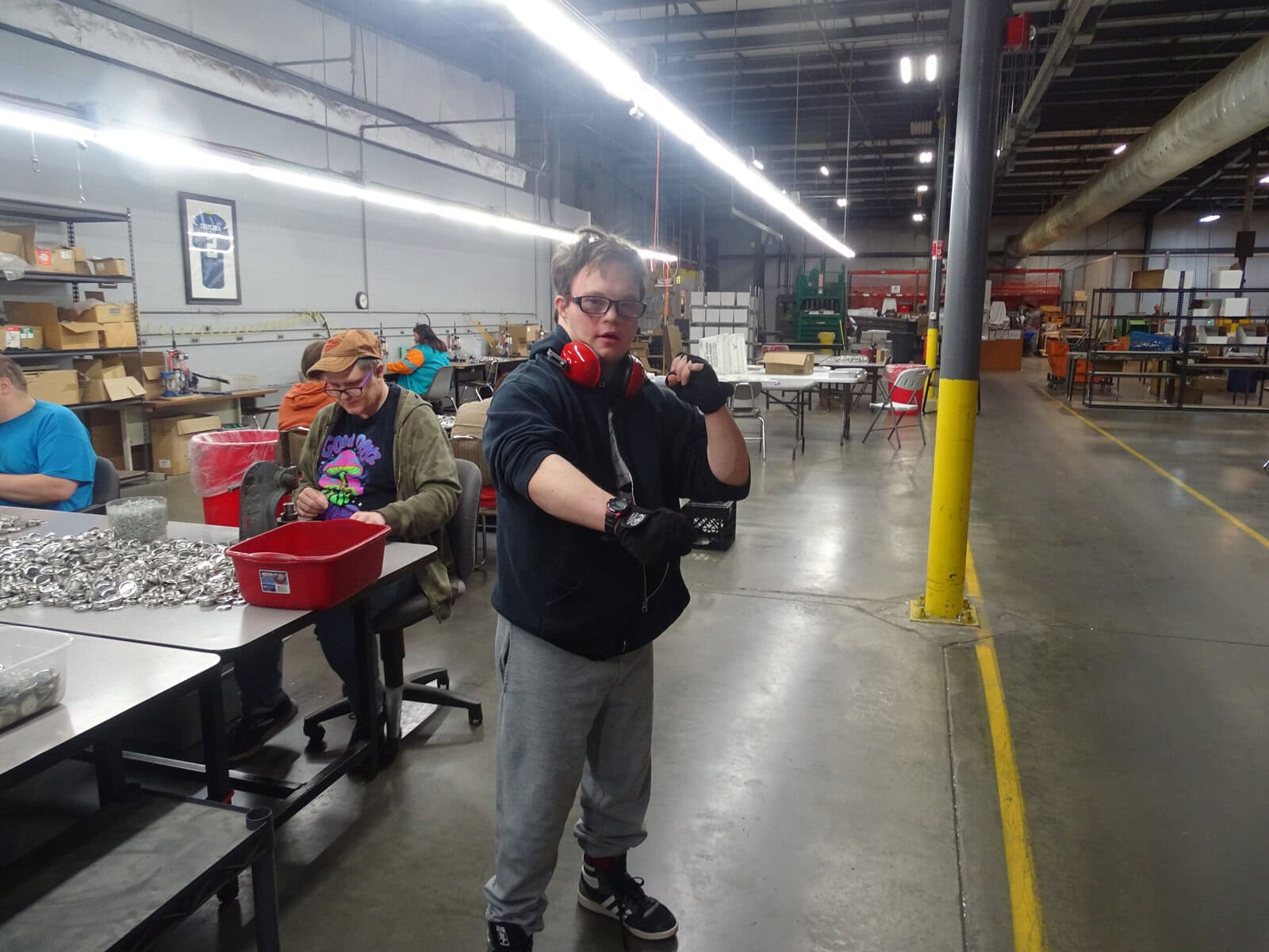 a man standing in the production area in a superhero pose