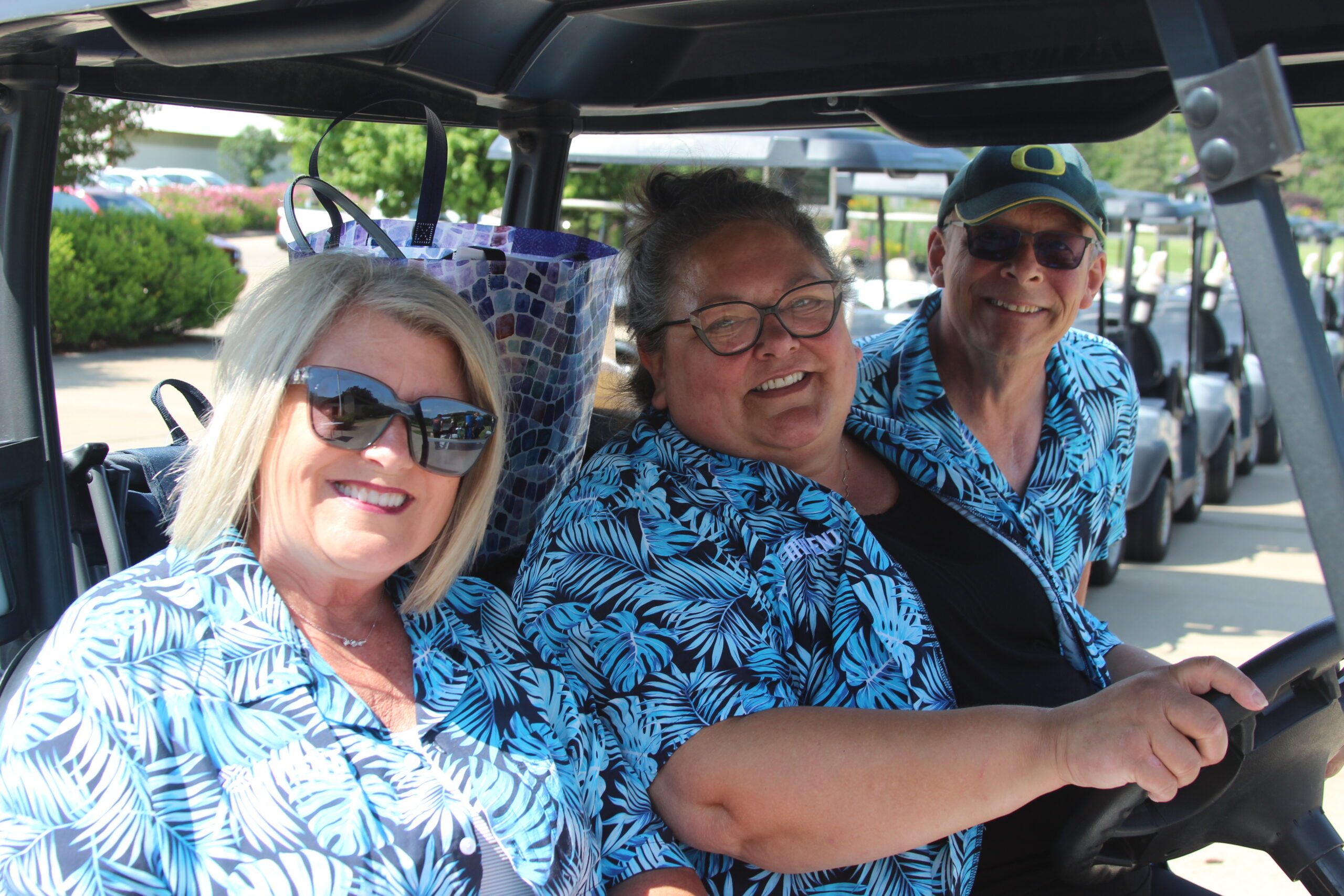 Marshmallow Hole Experts 2 ladies and a man in floral matching shirts