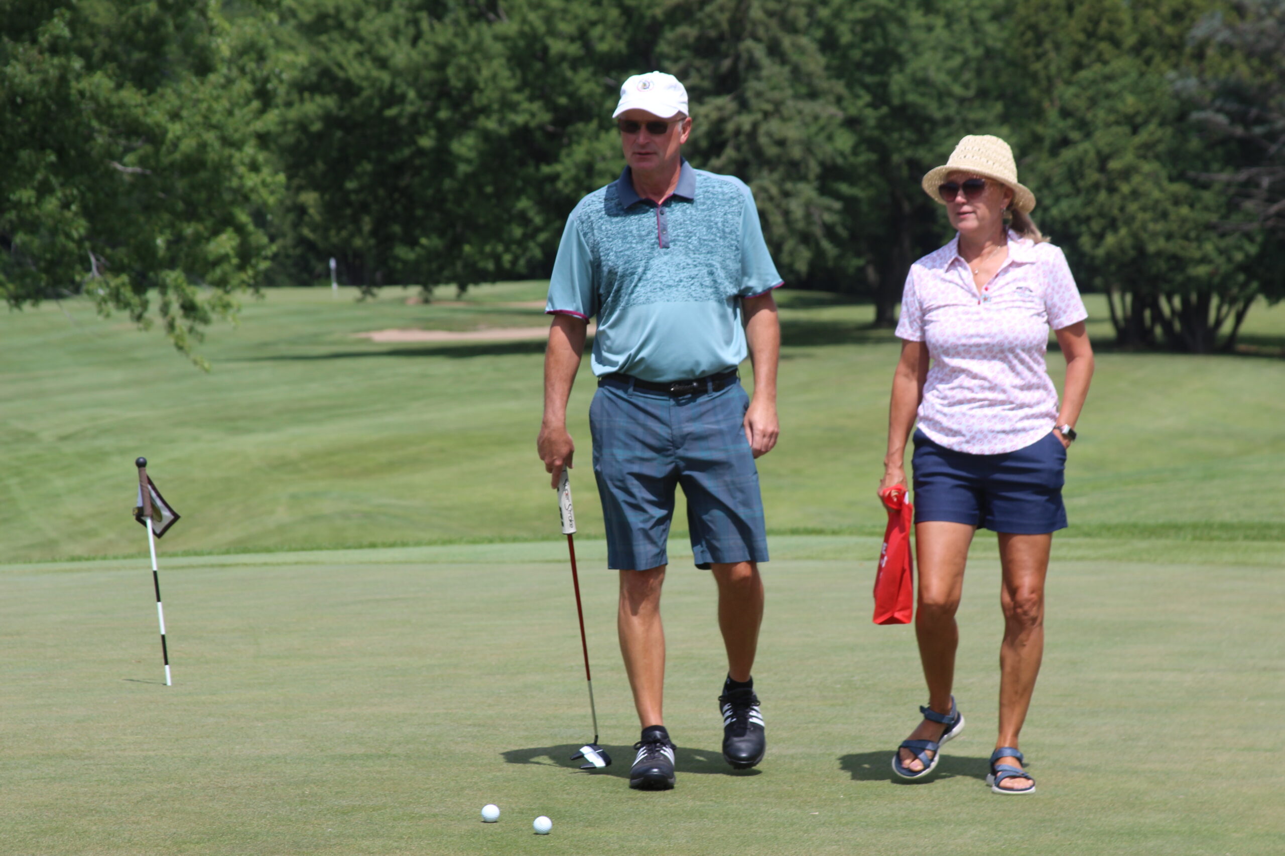 Media 19 Man and woman standing on golf green