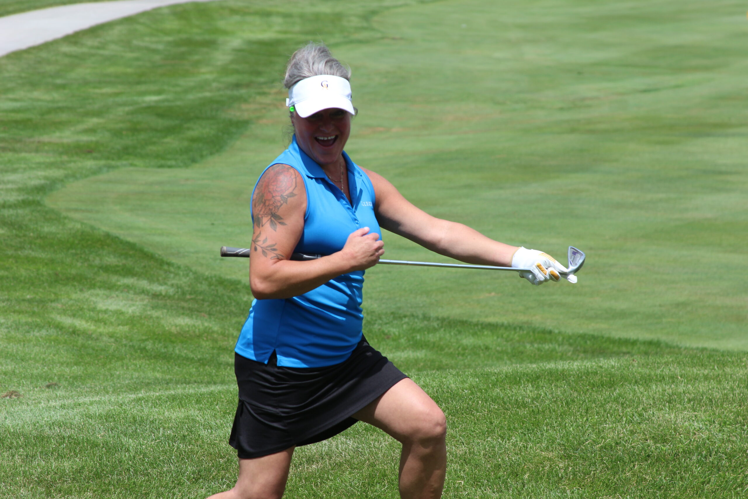 Media 24 woman smiling with her golf club horizontal