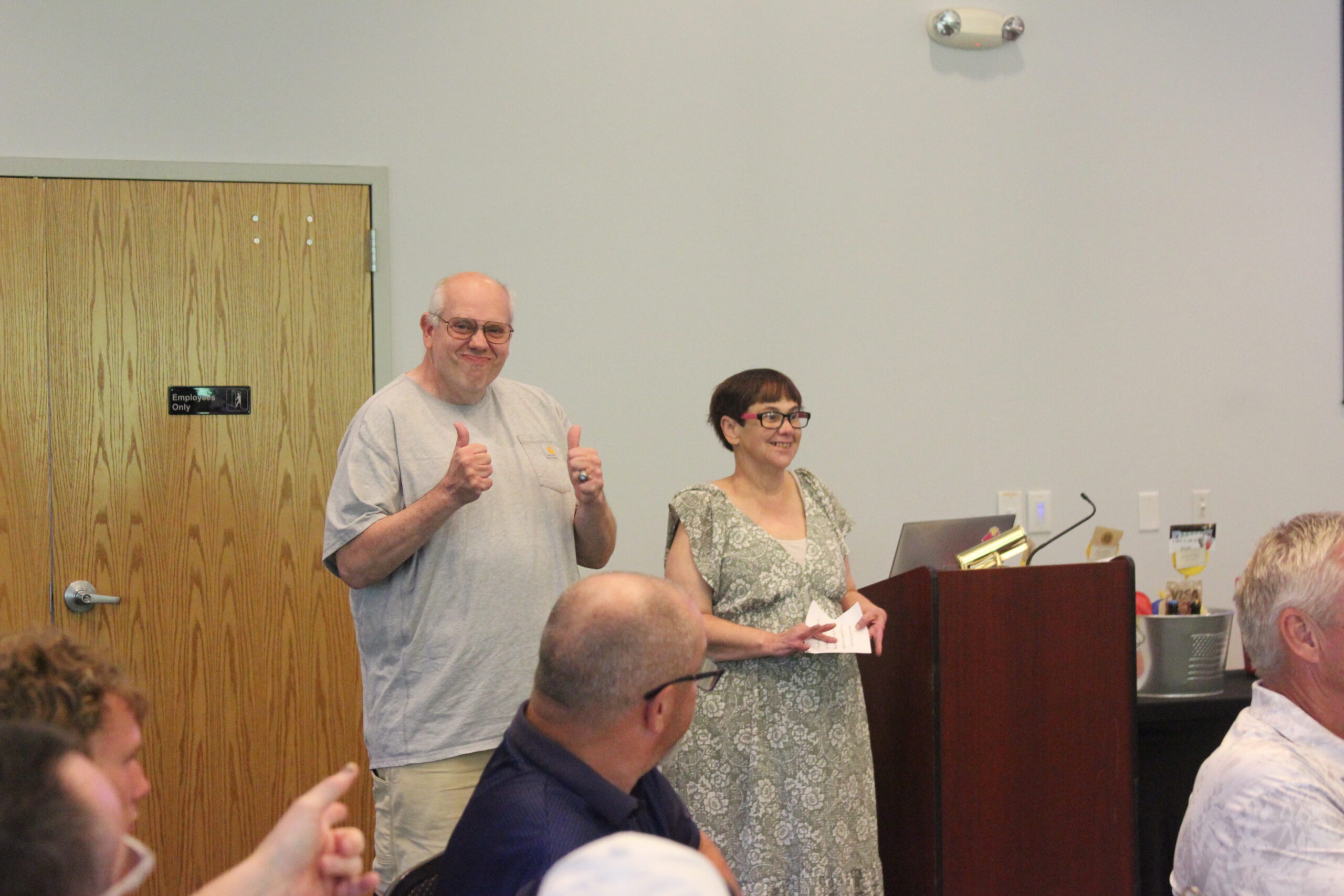 Media10 a man and a woman by the podium two thumbs up