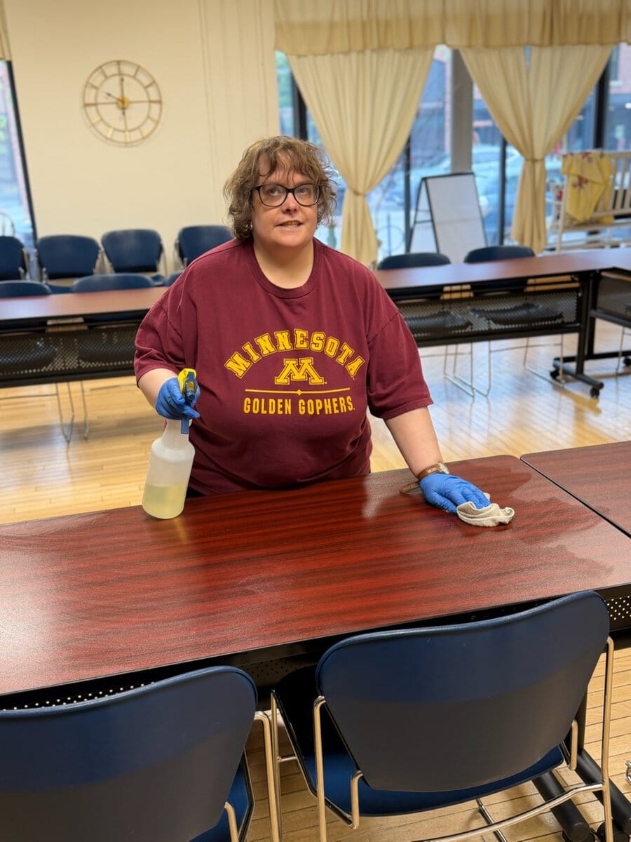 Woman sanitizing tables