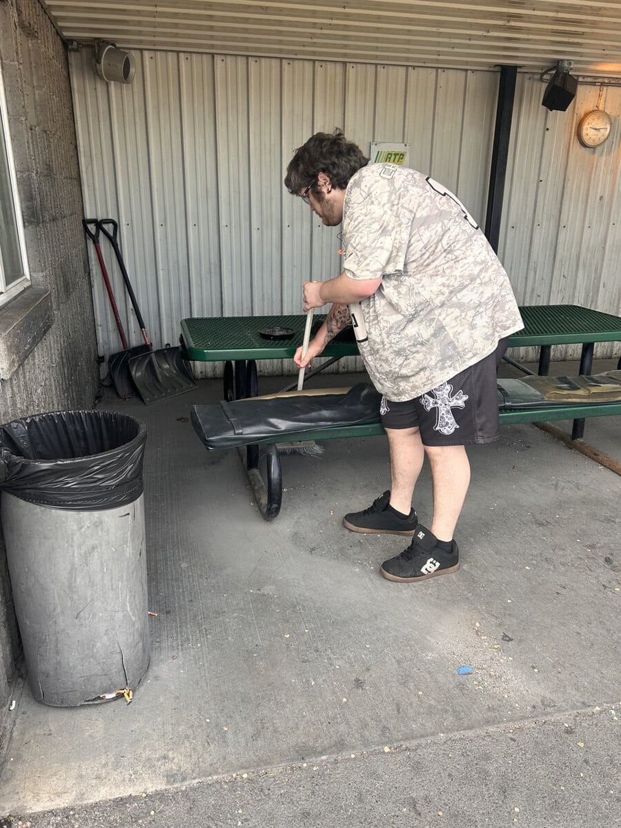 Man sweeping an outdoor space at RTP